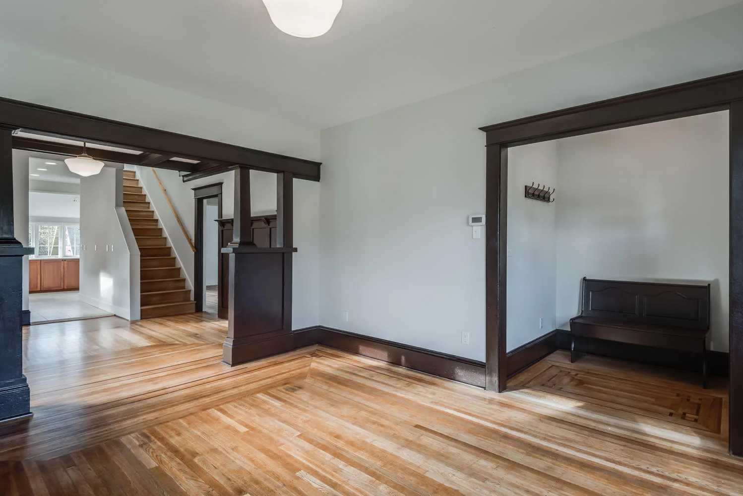Custom-build dining room with herringbone hardwood floor and craftsman trim